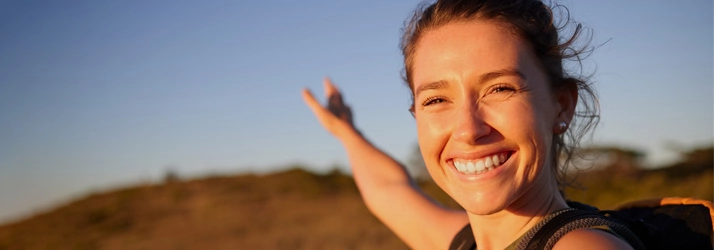A happy woman outside.